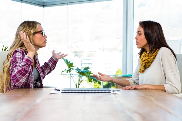 Two girls work at office and talking